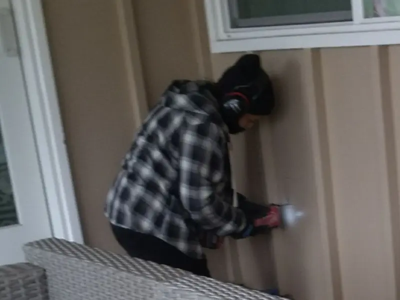 Professional electrician installing an exterior outlet in Morrow