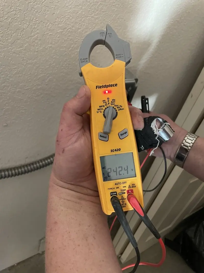 Voltage testing with clamp meter during Whole House Surge Protector in Morrow